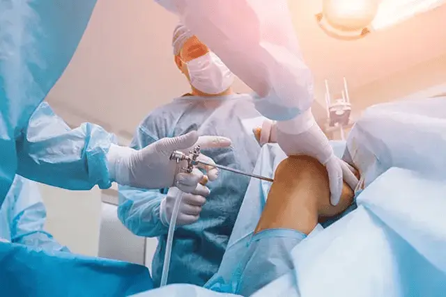 Orthopedic care team prepares patient for knee surgery in operating room