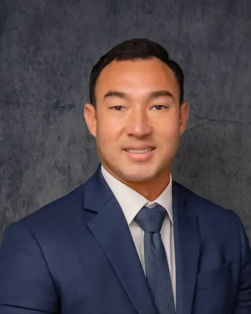 Podiatrist Dr. Matt Cikra smiling in a navy suit and tie